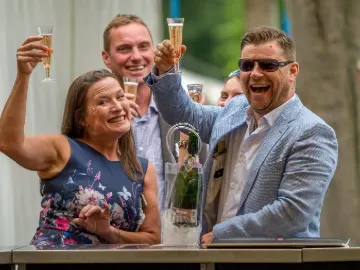 Race goers at Windsor toasting champagne to the camera