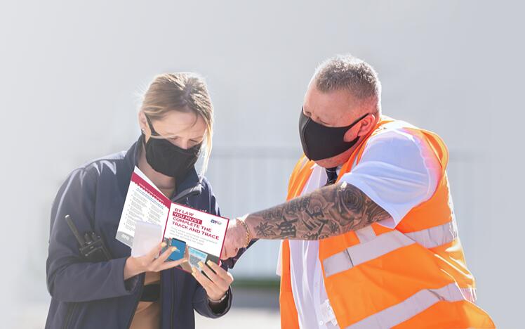 Customer at Windsor Racecourse being helped by racecourse official to enjoy her day at the races