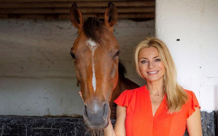 Tess Daily standing with a horse