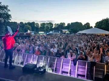 The view from the music stage at Windsor looking out at the dancing crowd at sunset