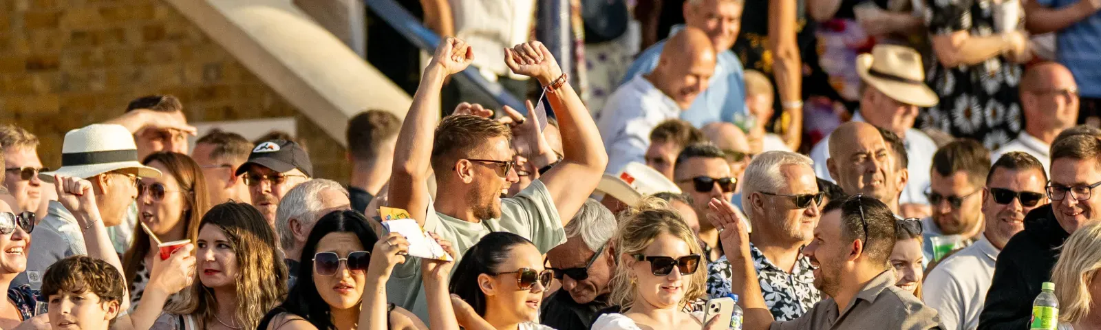 Some of the crowd at Windsor Races cheers for a win