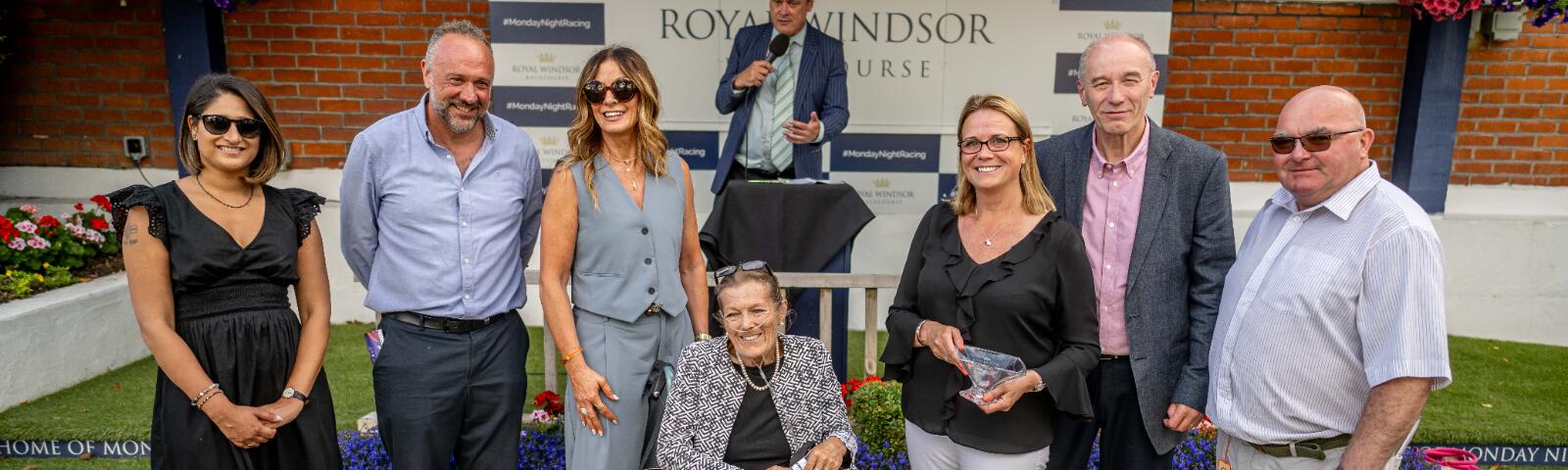 An owners and trainers group pose for their picture after a winning race at Windsor Races