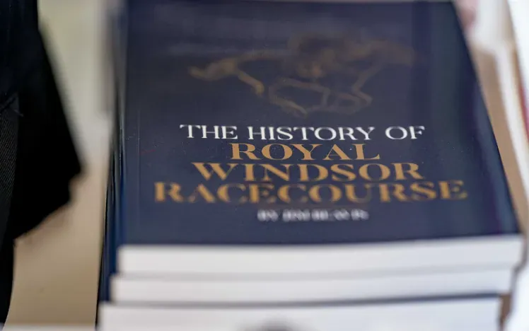 A close up of a stack of books of the history of Windsor races