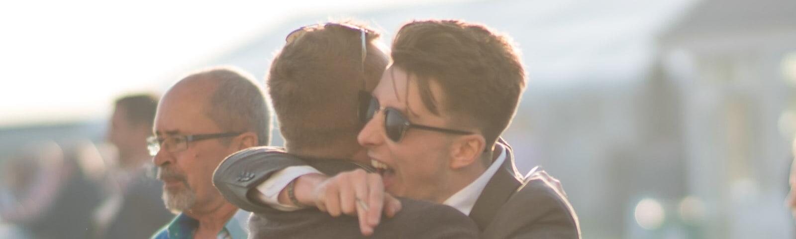 Two guys celebrating their win at Windsor Racecourse.