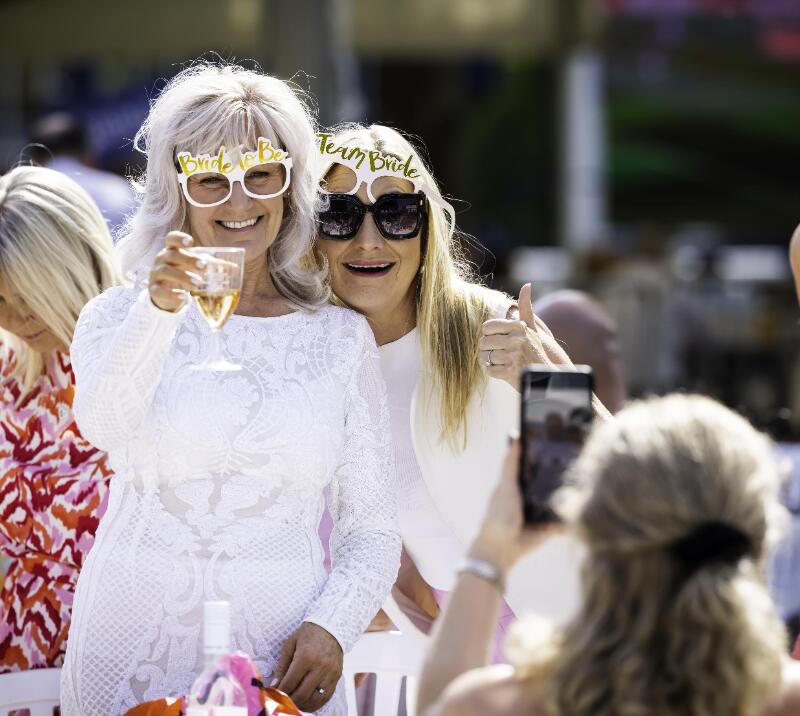 A bride to be poses with one of her hen party at Windsor Races