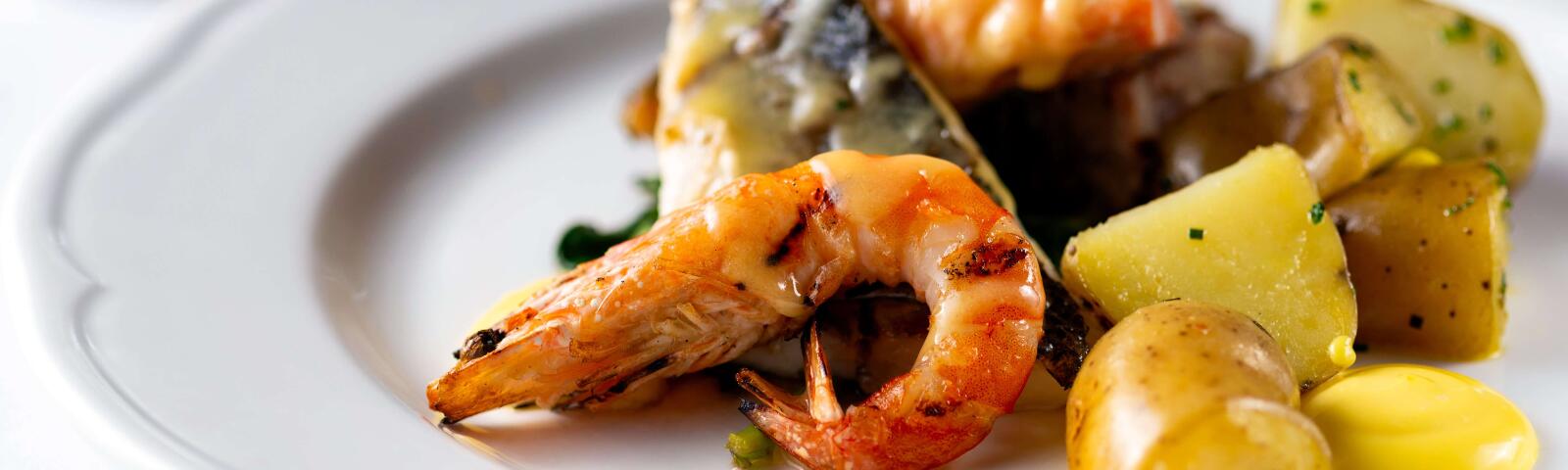 A close up of a delicious fish main course at Royal Windsor Racecourse.