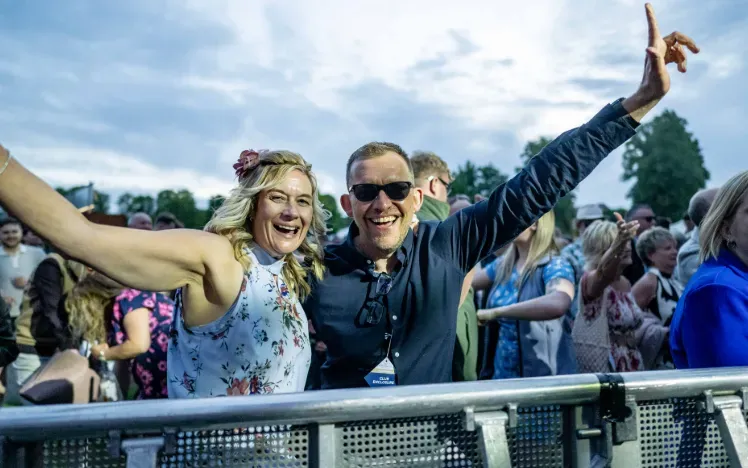 Two race goers at Windsor enjoying live entertainment
