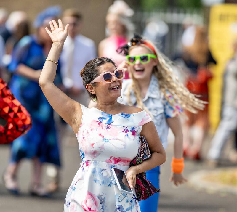 Race goers entering Windsor Races strike a pose